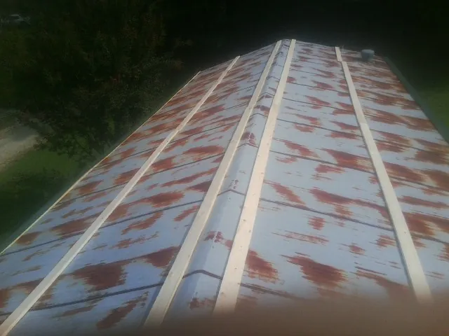 Rusted metal roof panels with new wood purlins before replacement — Storm Damage Roof Repair in Pawling by Roofing Brothers