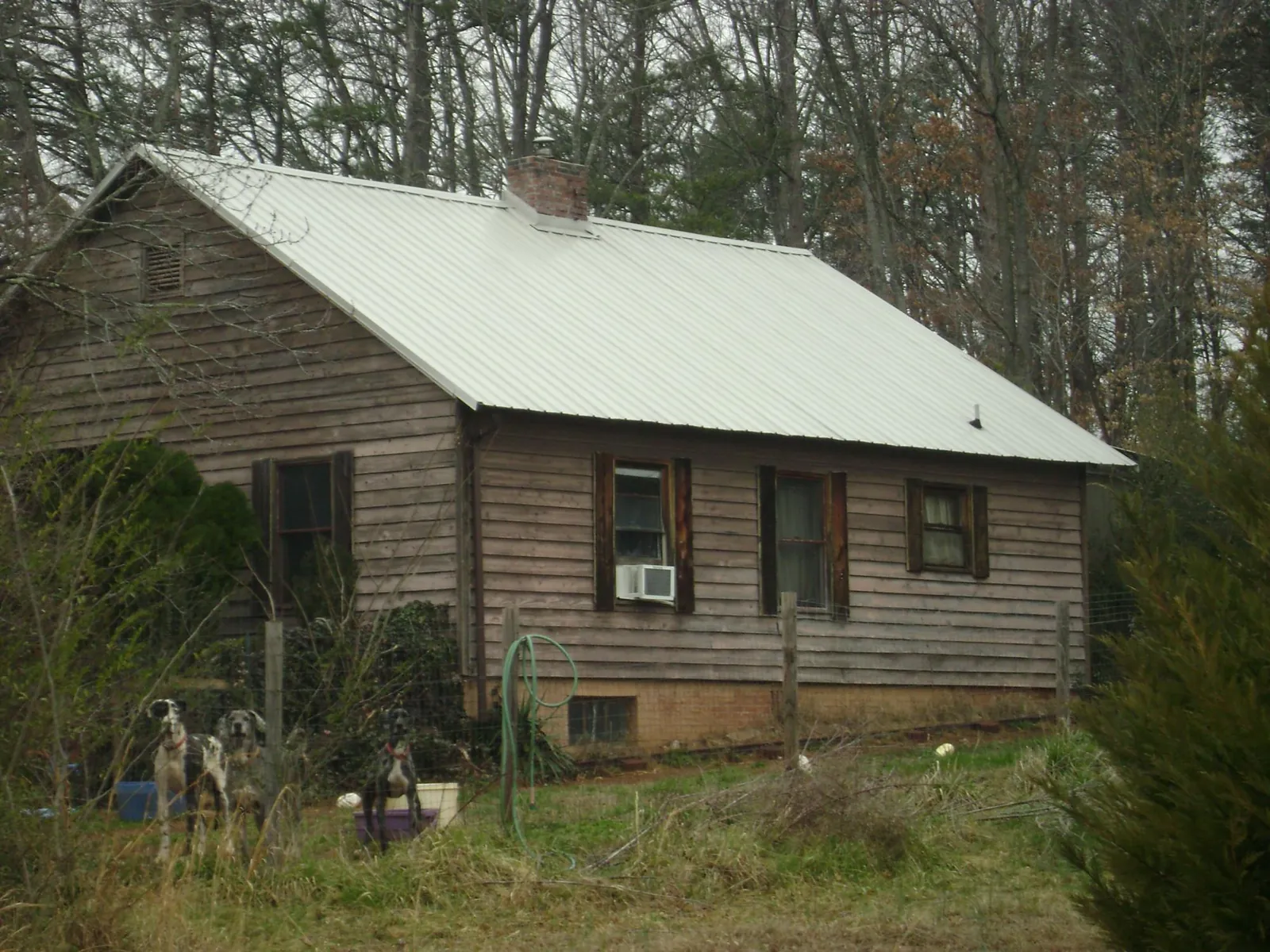 White metal roof on an old wood sided farmhouse, from a Metal Roof Installation job in Pawling